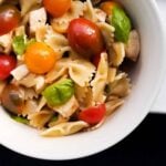 A bowl of caprese pasta salad that showcases Italian flavors.