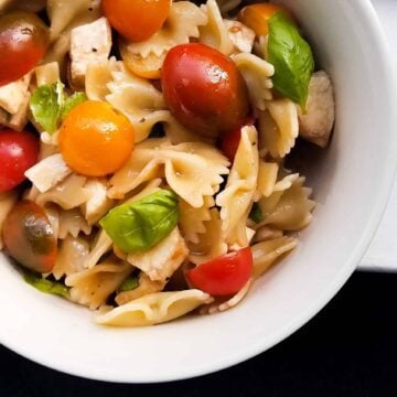 A bowl of caprese pasta salad that showcases Italian flavors.