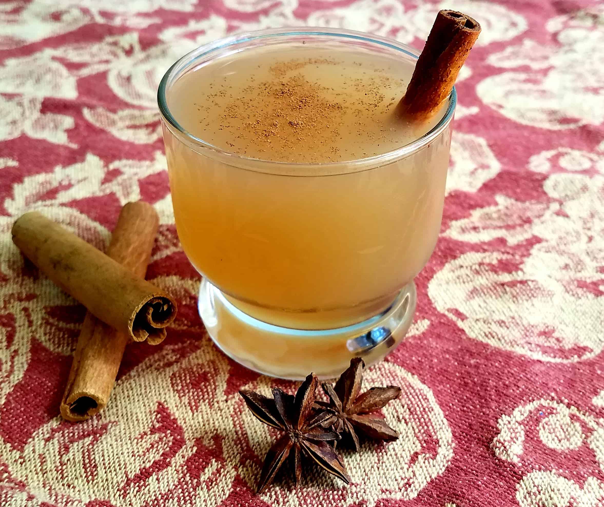 Delicious hot apple cider in a glass.