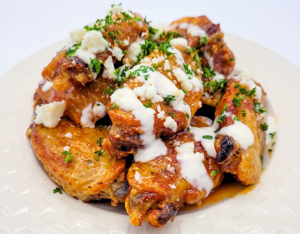 Hot honey chicken wings on a plate.