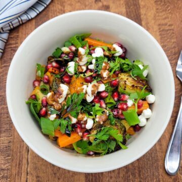 A bowl of colorful oven roasted vegetable salad.