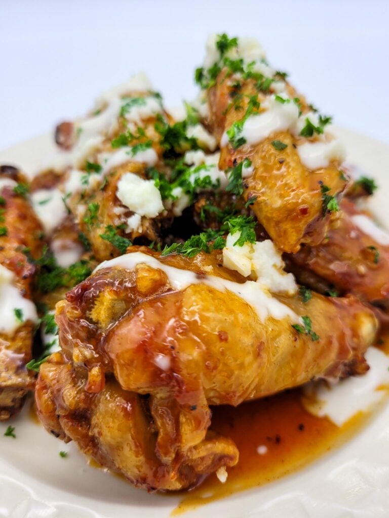 A view from the front of hot honey chicken wings prepared in an air fryer.