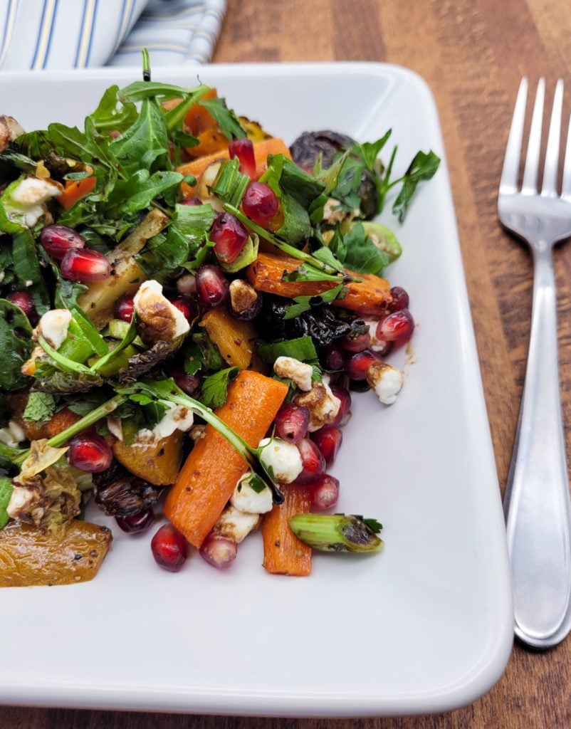Oven roasted vegetable salad on a square plate.