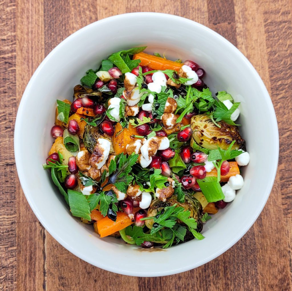 A bowl of colorful oven roasted vegetable salad.
