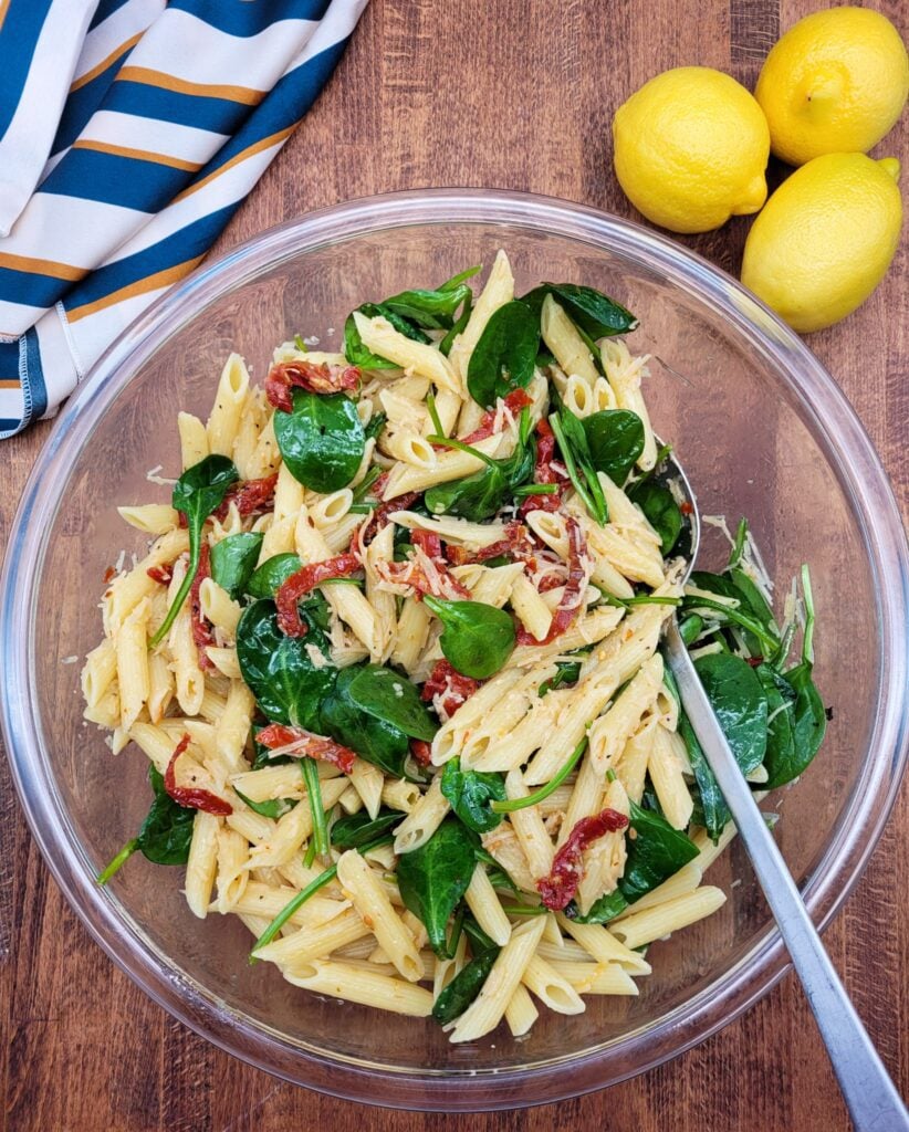 A large bowl of sun-dried tomato pasta salad