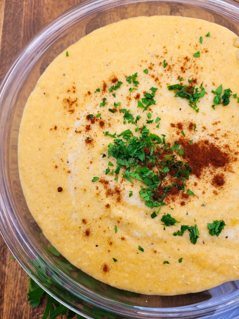 A close-up of a bowl of smoked gouda cheese grits.