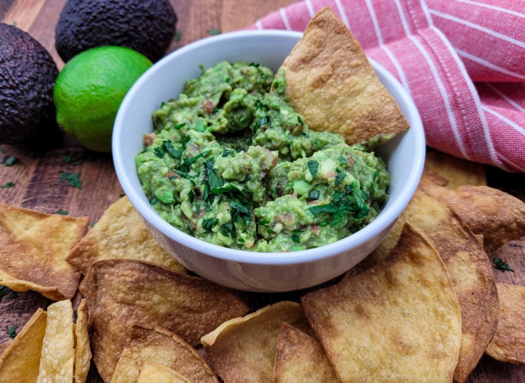Delicious 4 ingredient guacamole in a white bowl
