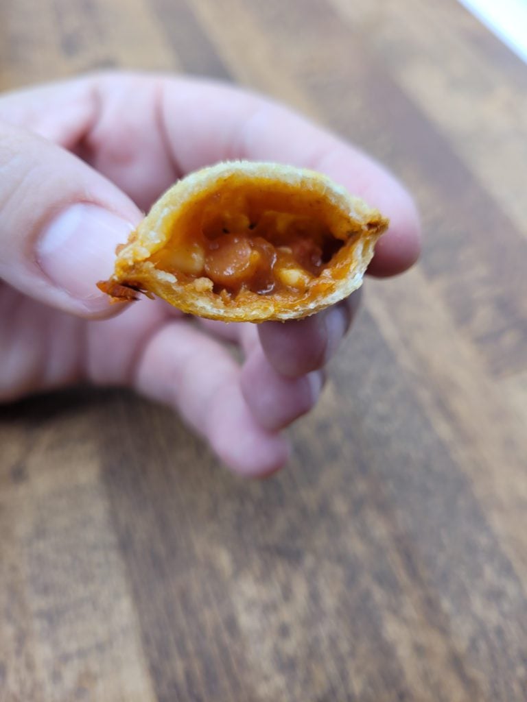 Air fryer pizza roll with a bite taken out