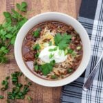 A bowl of Dutch oven chili with toppings.