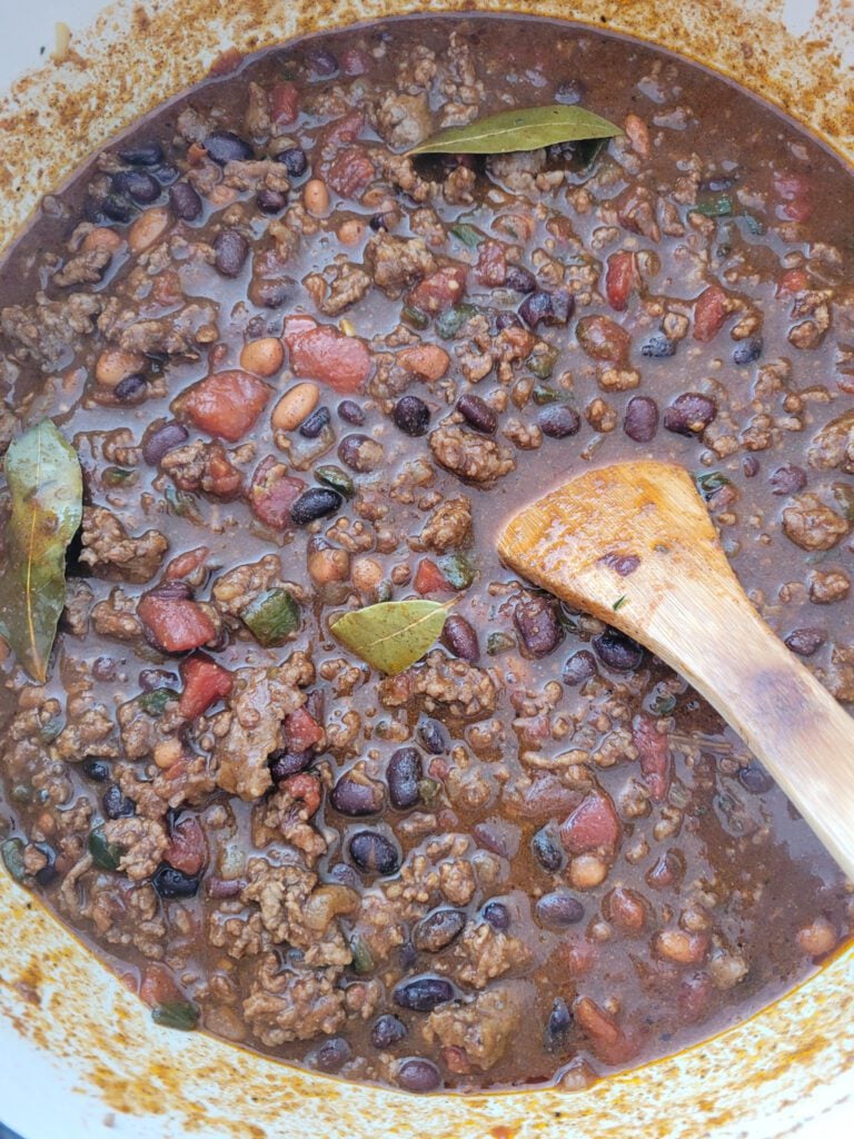 Stirring a Dutch oven filled with chili