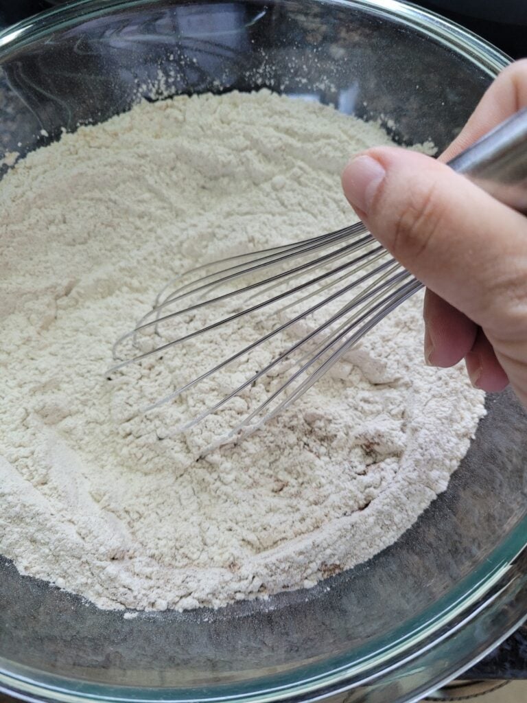 Whisking together dry ingredients for gingerbread cookies