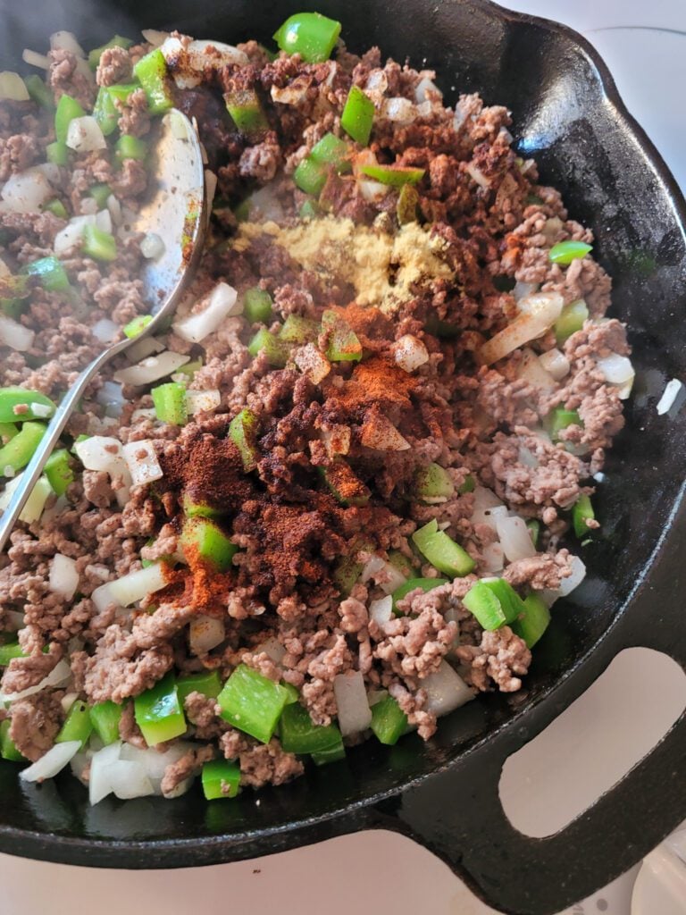 A skillet of browned ground beef with Sloppy Joe spices added