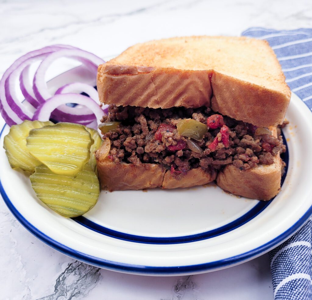 Texas Toast Sloppy Joe with a side of pickles and red onions