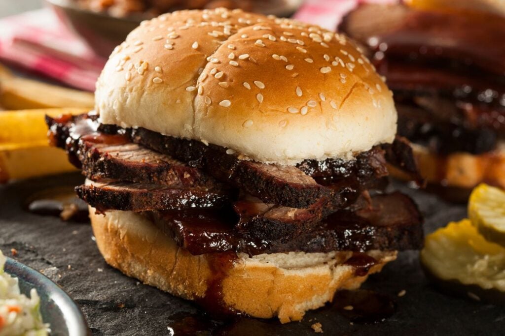 A brisket sandwich on a sesame seed bun