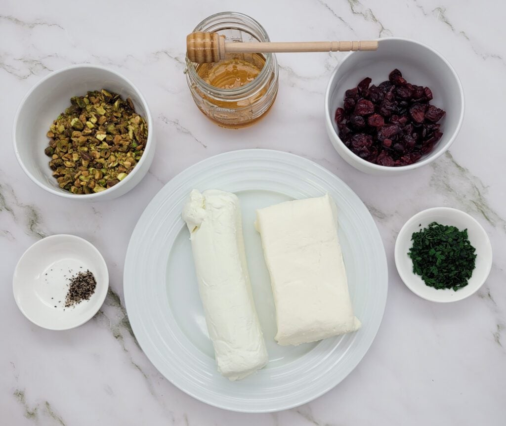 The ingredients used to make a Cranberry Pistachio Cheese Log