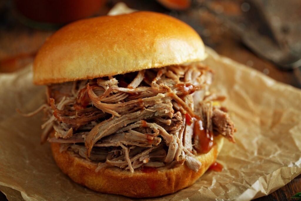 A large pulled pork sandwich on a bun
